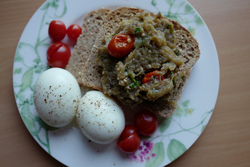 Eggplant Caviar (French) with Thyme Roasted Tomatoes over a toast next to eggs by Foodjoya