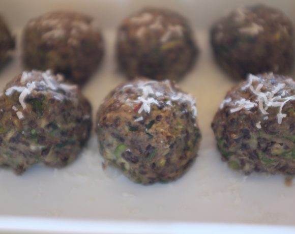 Beluga lentil meatballs, vegetarian, arranged in a row, by Foodjoya