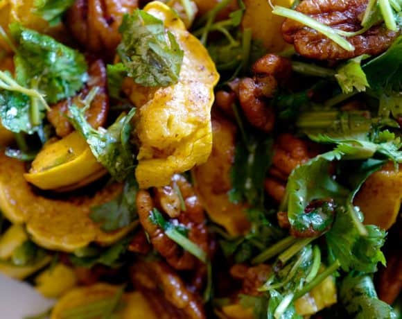 Delicata squash salad with herbs and spicy pecans close up by foodjoya