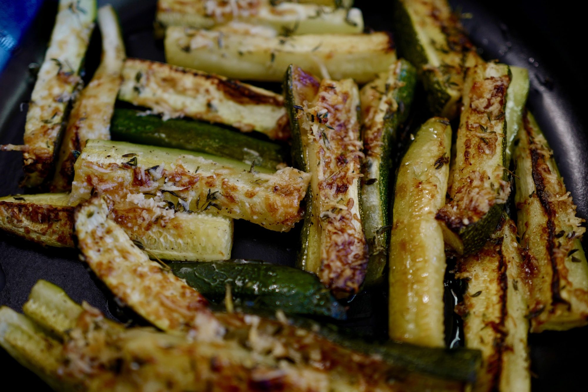 Parmesan Roasted Zucchini with thyme and avocado oil, close up by foodjoya
